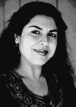 Dr.Divakaruni - black and white image, looking at camera smiling.