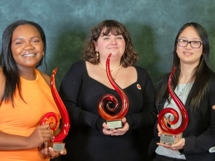 Three student leaders with awards