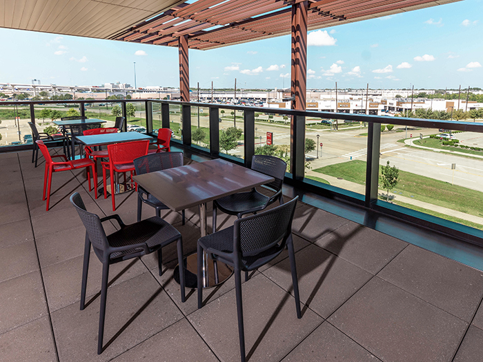 Table and chairs on a patio at UH at Katy