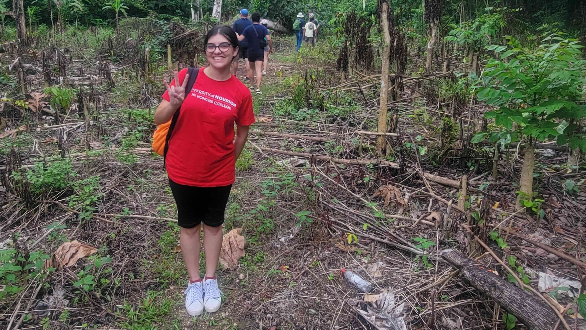 student standing in the forest in DR