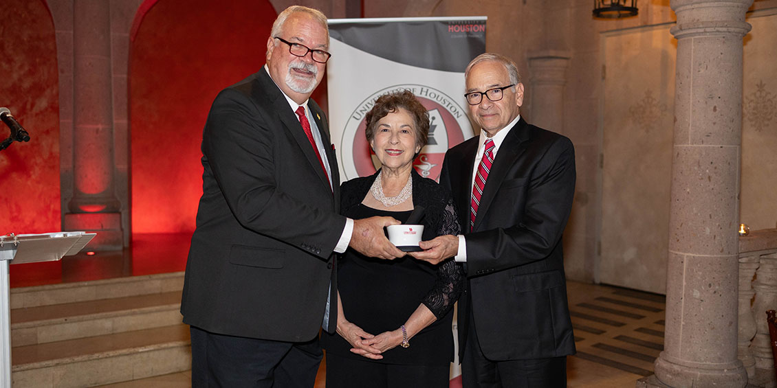 The Sandovals are presented with a mortar and pestle by Dean Pritchard.