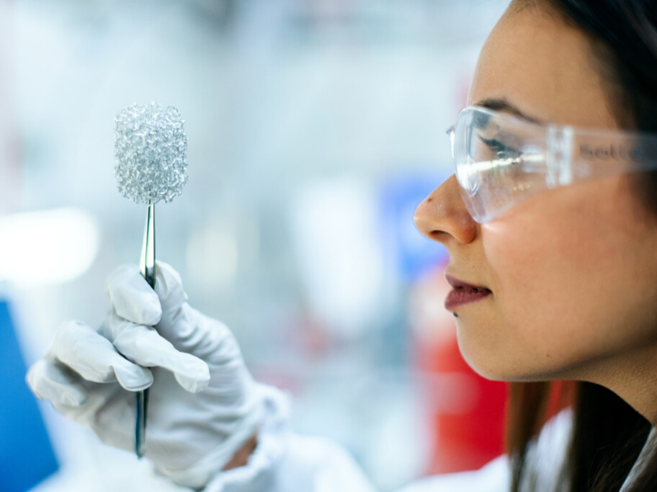 Scientist observing object in lab