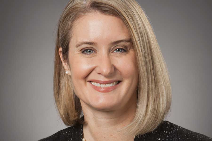 Portrait of a blonde woman smiling.